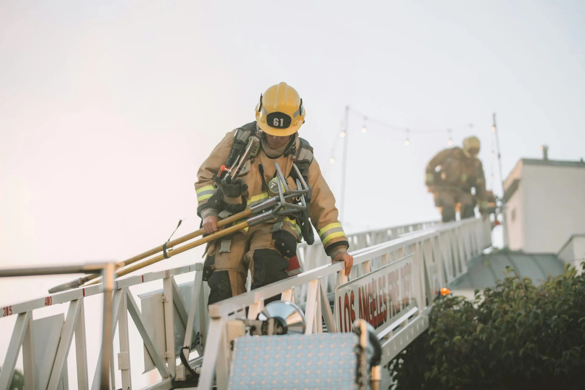 Firefighter climbing a ladder during operations