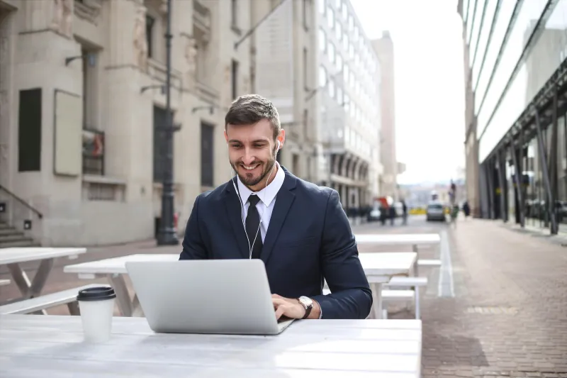 Candidate preparing answers on a laptop outside the station